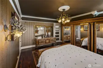 Closeup of wall sconce whose theme is mirrored in the chandelier.