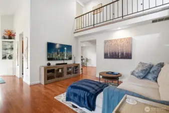 You enter into the living room with a two story vaulted ceiling.