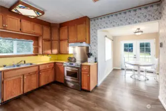 View form kitchen to sunny breakfast room. Laminate flooring throughout the house. Stainless steel appliances in kitchen. View toward backyard and Mount Baker from kitchen window as well as breakfast room.