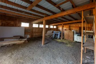 Additional covered storage at back of garage with entry from garage and from outside.