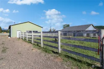 The shop building has an enclosed work shop area and open bays for machine or vehicle storage. There is lots of parking for the farm visitors