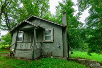 The existing house has 2 conforming bedrooms and 1 bathroom upstairs with a separate, non-conforming unit below with 3/4 bath. Both spaces have tenants paying minimal monthly rent.