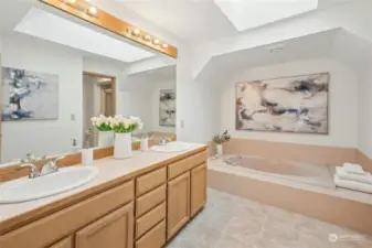 Dual sinks and a luxurious soaking tub + new flooring in the primary bathroom.