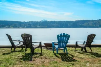 Can’t beat this view. Steps to the water, Mt. Rainier on the horizon, and your toes in the sand—every day.