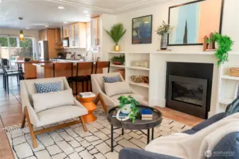 Front entry/living room has a gas fireplace and built-in book shelves