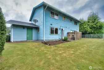 Backyard fenced complete with garden bed