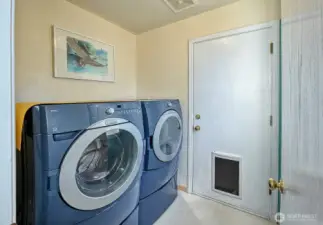 Laundry room with door to garage.