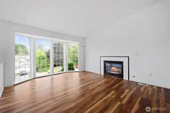 Light filled living room with gas fireplace.