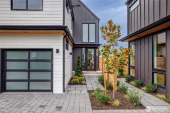 Secluded front entry with attached one car garage.