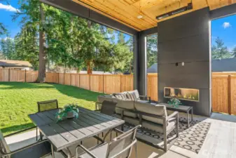 Large patio with sitting and eating area, with heaters