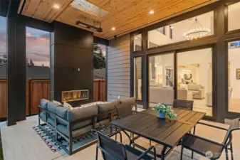 Large patio with sitting and eating area, with heaters