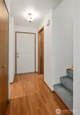 Entry showing the 1st floor half bath and laundry door.