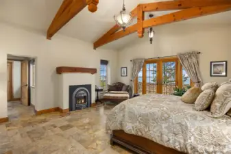 Open beams, heated Travertine flooring and a gas burning fireplace complete this elegant setting.