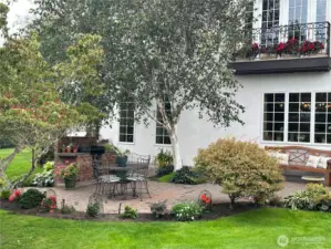 Lovely back patio for dining al fresco. Brick grilling station, also works well for marshmallow roasting.