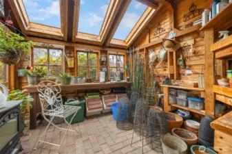 Multiple skylights and shelves along with a long work bench make this a gardener's delight.