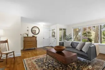 Large, west facing windows create a living room with natural light. A high-efficiency HVAC system, installed in 2023, with a furnace and heat pump/air conditioning keeps the home comfortable all year.