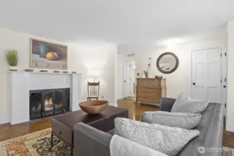 Three bedrooms, 1.75 bathrooms, and storage are located off of the hallway in the center of this photo. Hardwood flooring extends through the living room, hallway, and all three bedrooms. The updated kitchen, dining, and family room have coordinating LVP flooring.