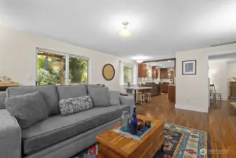The doorway at the far right leads to the living room and entry. The large slider opens to a covered patio perfect for PNW outdoor living.