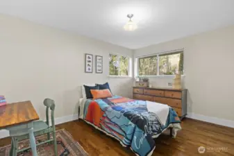 Bedroom 2 is roomy and has windows on two walls.