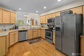 Plenty of counter space in the kitchen with opening into the living room.