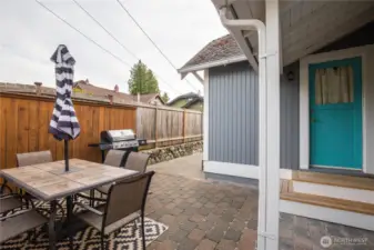 The fenced backyard has a nice patio area for outdoor entertaining and barbecues.