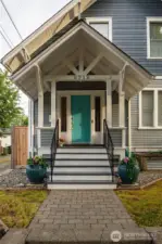 The covered front porch beckons you to come inside.