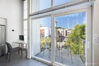 Windows from floor to ceiling. Sliding glass doors to the balcony.