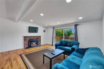 Upstairs living area with firpelace to cozy up to and beautiful wood floors.