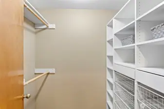 Primary walk-in closet with updated built-ins.