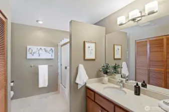 Updated primary bathroom with designer colours and a walk-in shower.