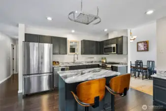 Modern kitchen showcasing a center island and granite countertops.