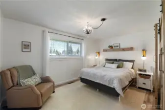 Master bedroom with shiplap and built in side lamps.