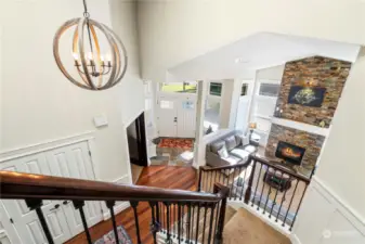 View of stunning large staircase and new modern lighting as you walk up or down stairs in home!