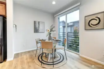 Dining area with a sliding glass door for fresh air and ventilation.