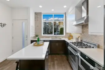 Kitchen welcomes you! Gas cooking, an added island for baking and entertaining, and window over the sink.