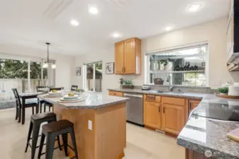 More good lighting and garden window lets in the daylight! Lots of granite counters, cabinets + pantry and center island together make for a very friendly kitchen!