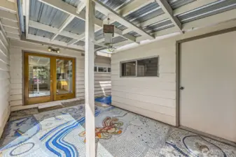 Private, covered patio with custom mosaic