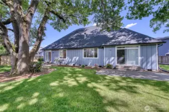 Large private backyard with dual sliding doors and patios for ease of enjoyment.