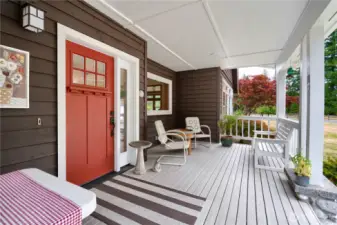 Large covered front porch with seating areas highlights the front of this home.
