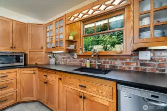 Ample cupboard and storage space. Cabinets are solid wood and feature undercabinet lighting. Kitchen window overlooks the backyard.