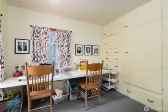 Main floor, bedroom 1. Currently setup as a craft and playroom! Check out the built-in closet/dresser!