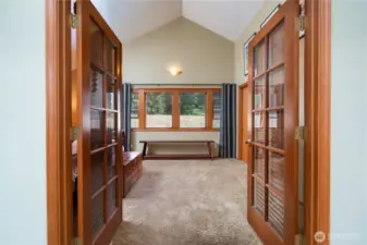 Primary bedroom has french doors to close off the adjacent living room.