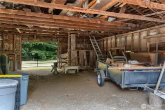 Inside of barn looking to West pasture area. Additional covered area along North side of structure to keep horses out of weather.