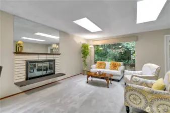 The living room is flooded with light and has a cozy gas fireplace...