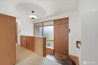 Classic 60's entrance with slate, along with beautiful mahogany built-ins.