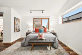 large primary bedroom with dramatic ceilings