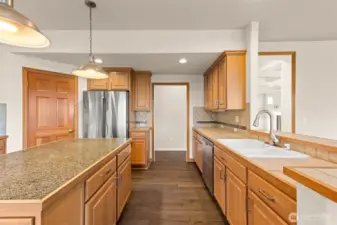 Kitchen with hall to half bath and downstairs bedroom, as well as garage access