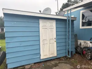 Storage shed on side of home