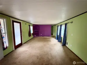 View of living room from the kitchen. (front entrance is door on left)