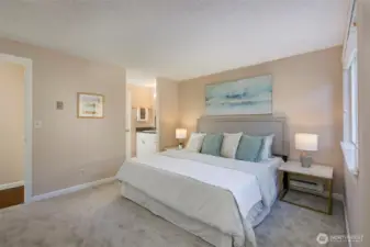 Second view of primary bedroom that flows into full bath